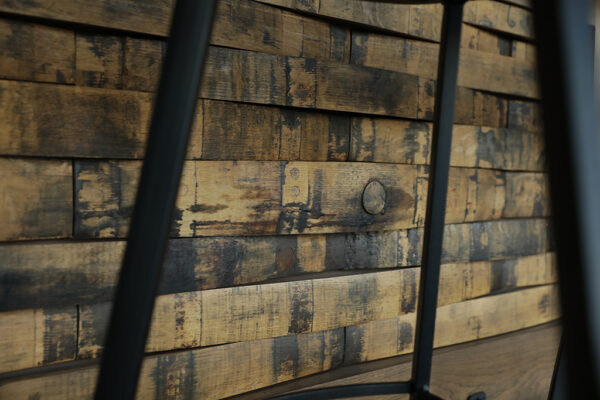 Planks of weathered wood installed on a vertical surface.